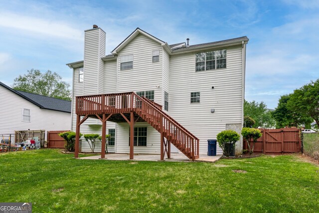 back of house featuring stairs, a lawn, a fenced backyard, a patio, and a gate