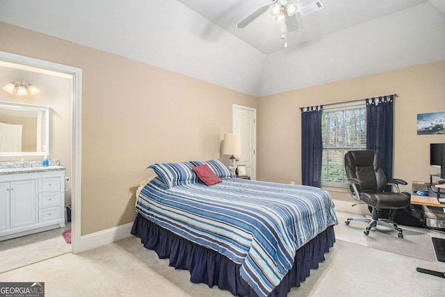 bedroom featuring vaulted ceiling, visible vents, ensuite bath, baseboards, and light colored carpet