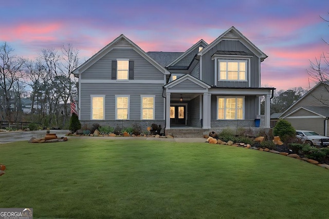 view of front facade with stone siding, board and batten siding, and a front lawn