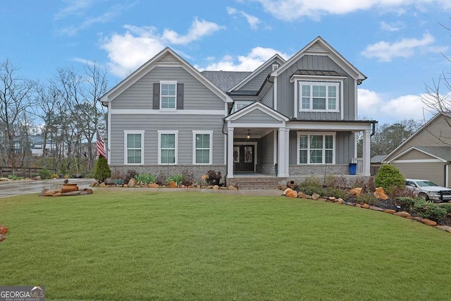 craftsman-style house with brick siding, board and batten siding, and a front lawn