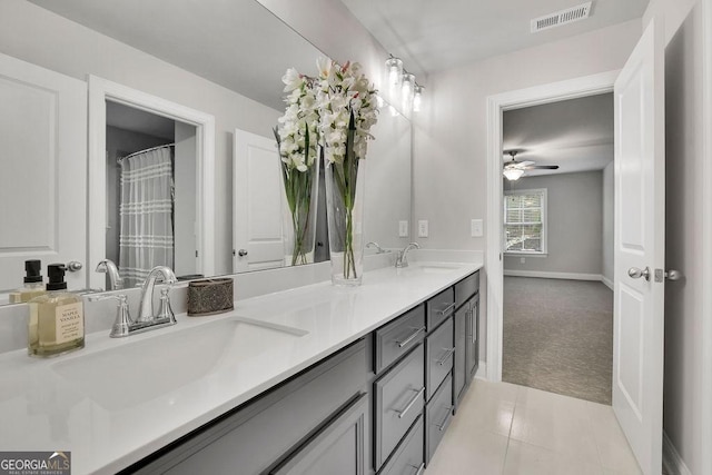 full bath featuring a sink, visible vents, double vanity, and tile patterned flooring