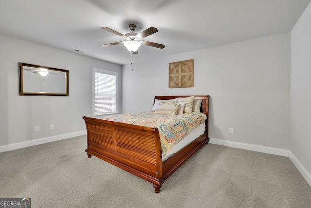 carpeted bedroom featuring visible vents, baseboards, and ceiling fan