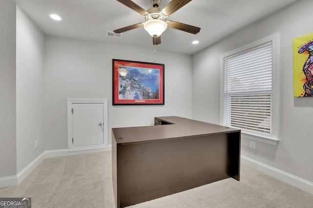 unfurnished office with visible vents, light colored carpet, and baseboards