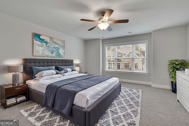 bedroom featuring visible vents, baseboards, carpet, and ceiling fan