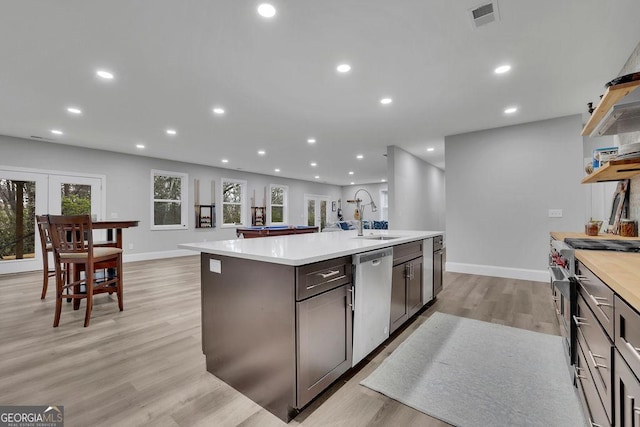 kitchen with visible vents, recessed lighting, a sink, stainless steel appliances, and light countertops