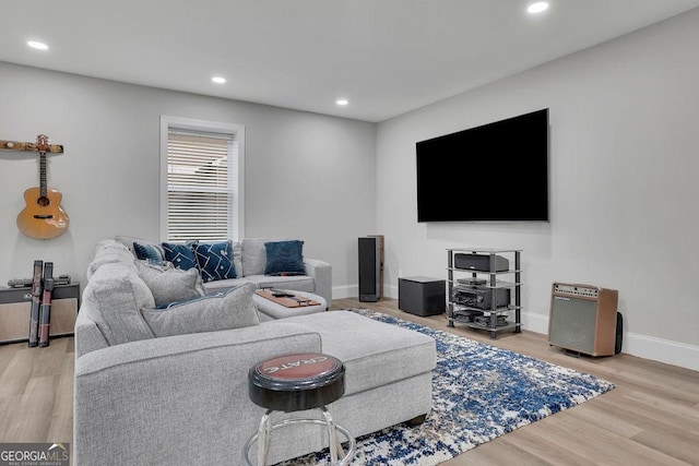 living area with recessed lighting, baseboards, and wood finished floors