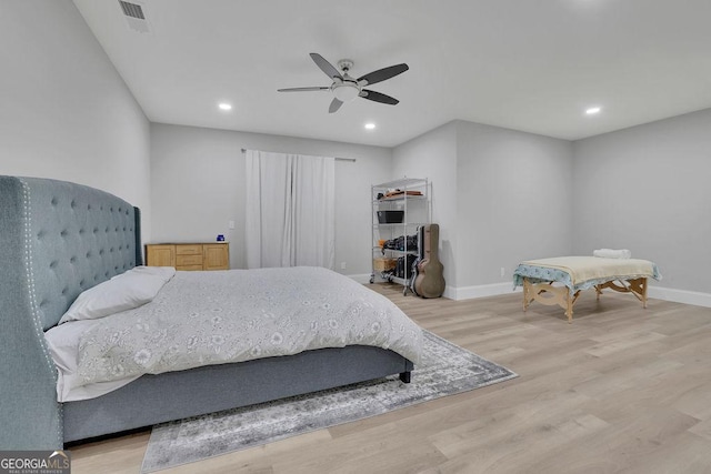 bedroom with a ceiling fan, visible vents, baseboards, light wood finished floors, and recessed lighting