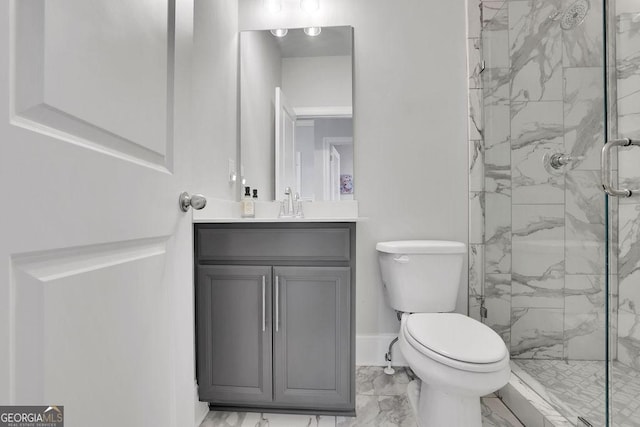 full bathroom featuring a marble finish shower, baseboards, toilet, marble finish floor, and vanity