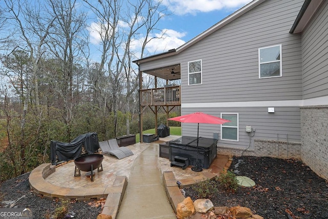 view of patio / terrace with an outdoor fire pit and ceiling fan