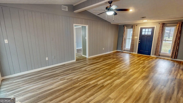 foyer with lofted ceiling with beams, light wood-style flooring, baseboards, and visible vents