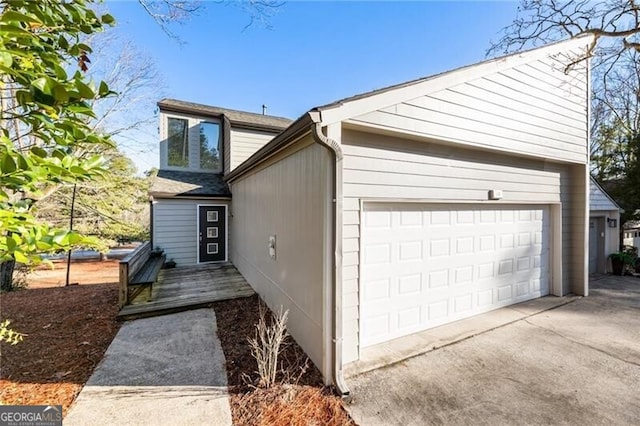 view of front of house featuring concrete driveway and an attached garage