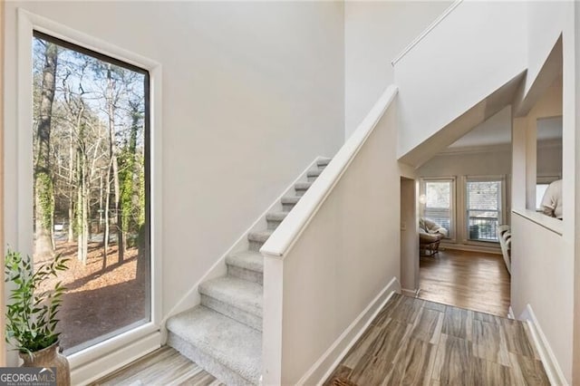 interior space featuring stairway, baseboards, and wood finished floors