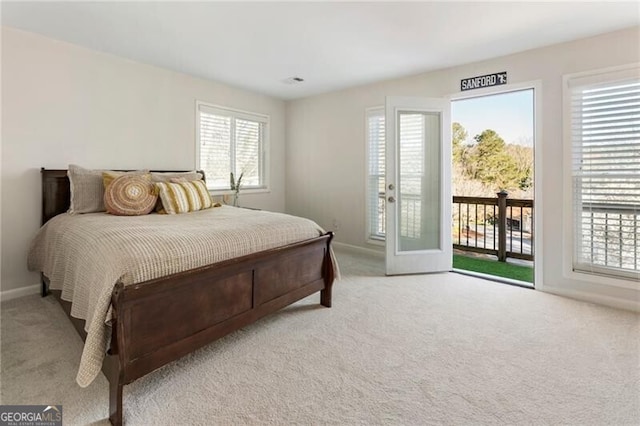 bedroom with baseboards, carpet, and access to outside