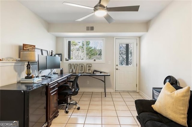 office space featuring light tile patterned floors, visible vents, baseboards, and a ceiling fan