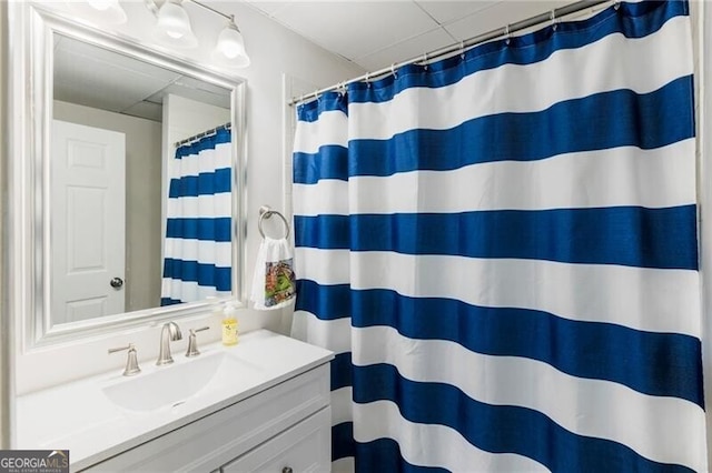 bathroom featuring curtained shower and vanity