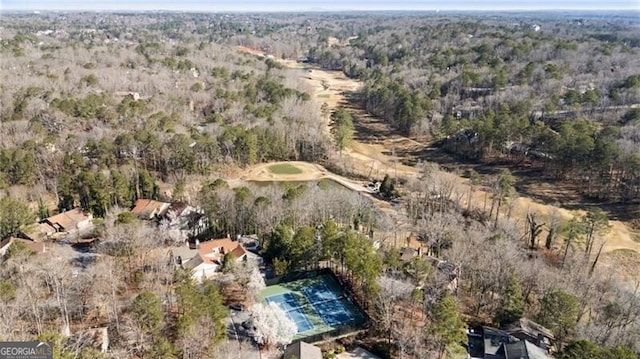 birds eye view of property with a wooded view