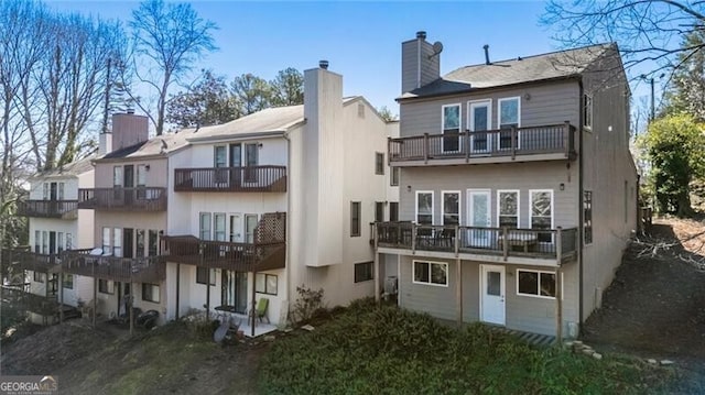 10 Colony Ridge Dr, Alpharetta, GA 30022 - back of house featuring a balcony and a chimney