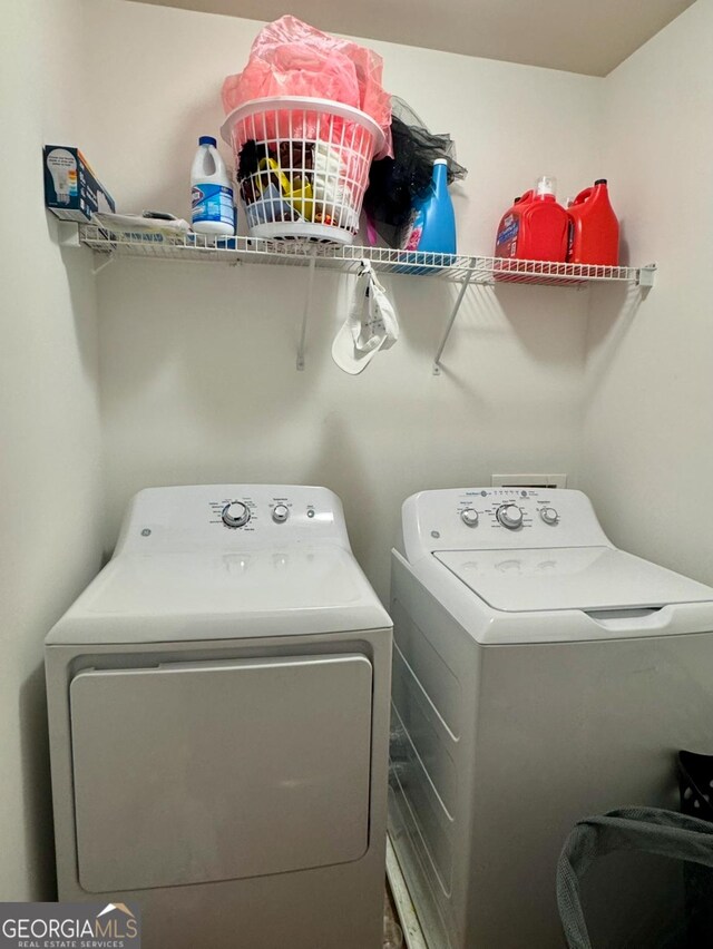 washroom with separate washer and dryer and laundry area