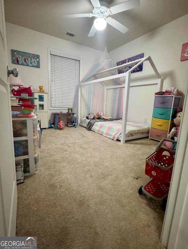 carpeted bedroom with visible vents and ceiling fan