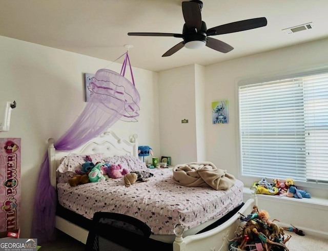 carpeted bedroom with visible vents and ceiling fan