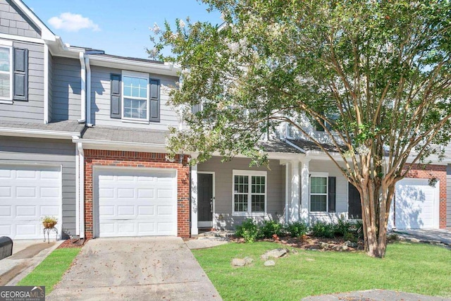 view of property with a front lawn, a garage, concrete driveway, and brick siding