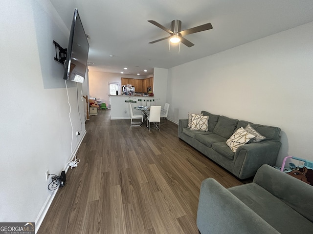 living room with baseboards, recessed lighting, ceiling fan, and dark wood-style flooring
