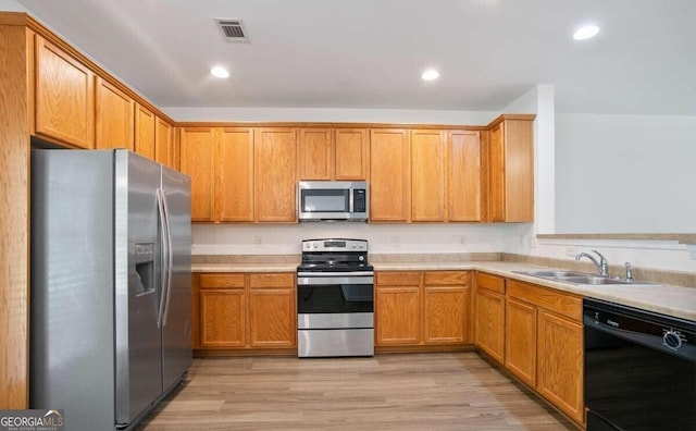 kitchen with a sink, appliances with stainless steel finishes, visible vents, light countertops, and recessed lighting