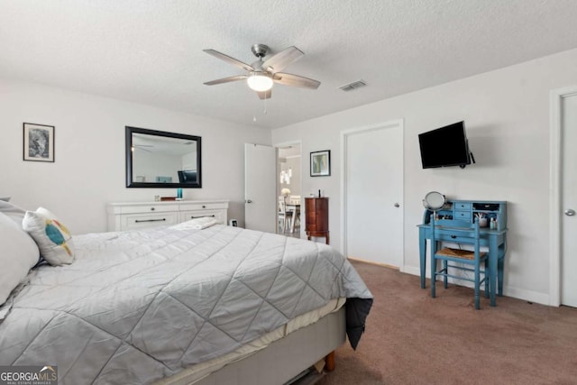 bedroom featuring visible vents, a ceiling fan, a textured ceiling, carpet floors, and baseboards