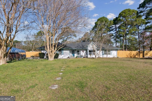 single story home featuring a front yard and fence