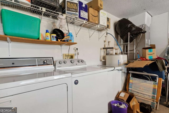 laundry area with laundry area, washing machine and dryer, and a textured ceiling