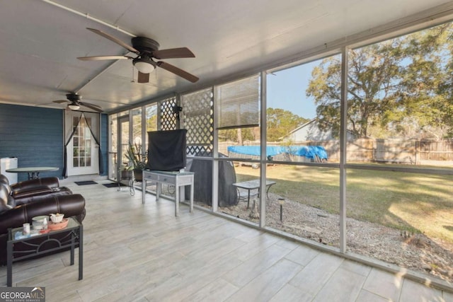 sunroom featuring a ceiling fan