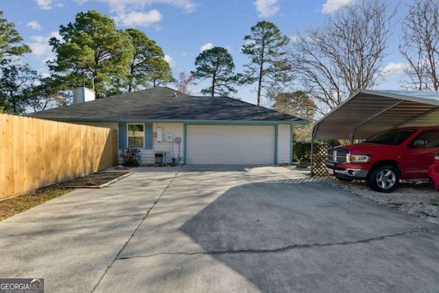 exterior space featuring a garage, a carport, concrete driveway, and fence