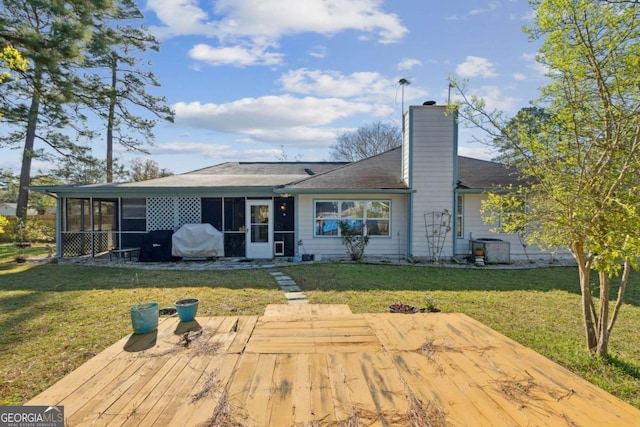 back of house featuring cooling unit, a lawn, a sunroom, and a chimney