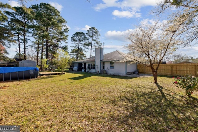 view of yard featuring a fenced in pool and fence