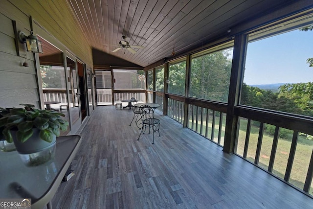 sunroom featuring ceiling fan, wood ceiling, and lofted ceiling