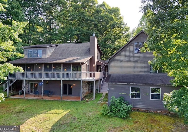 rear view of house with a yard, a patio, a chimney, and stairs