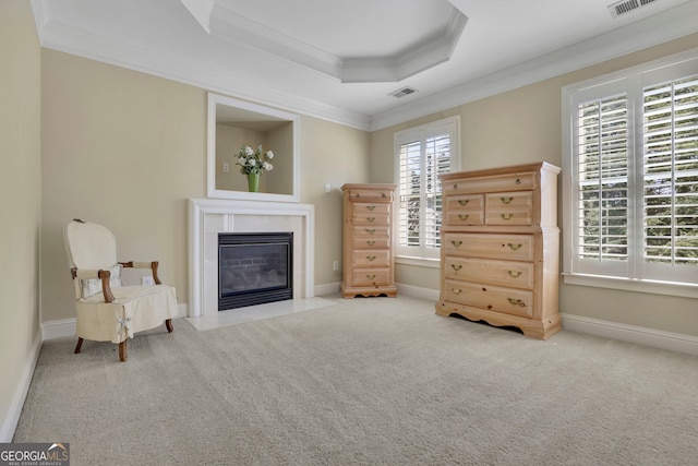 living area with a fireplace with flush hearth, ornamental molding, baseboards, carpet flooring, and a raised ceiling