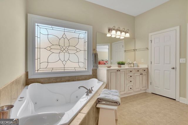 bathroom featuring double vanity, a sink, a whirlpool tub, and tile patterned floors