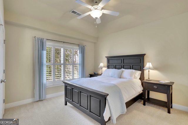 bedroom with visible vents, light carpet, baseboards, and ceiling fan