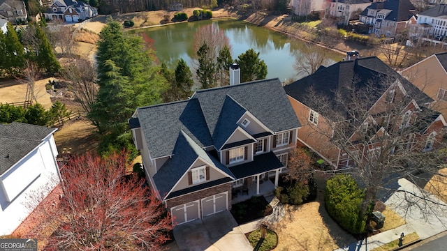 aerial view featuring a water view and a residential view