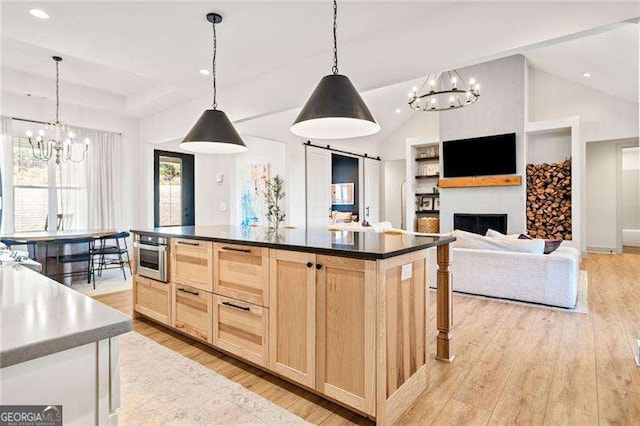 847 Cumberland Ave, Dallas, GA 30157 - kitchen with light wood-style flooring, light brown cabinetry, dark countertops, a fireplace, and vaulted ceiling