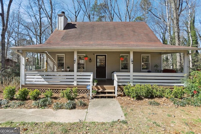 country-style home featuring a porch and a chimney