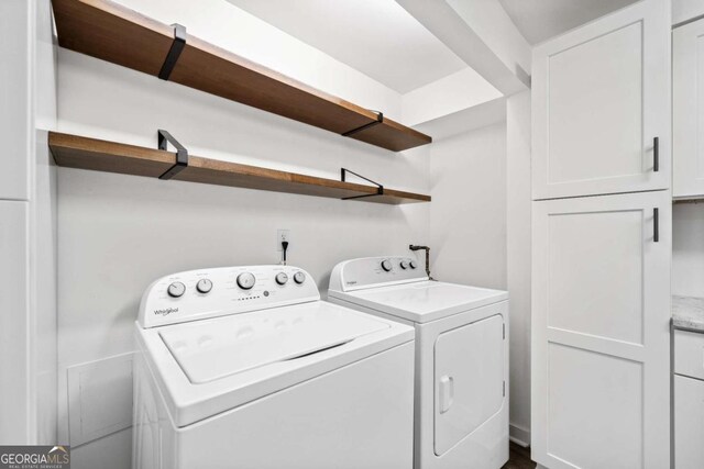 laundry area featuring cabinet space and separate washer and dryer