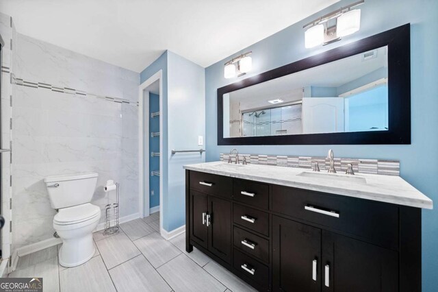 full bathroom with walk in shower, double vanity, toilet, and a sink