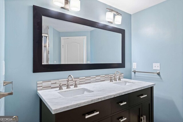 bathroom with a sink and double vanity