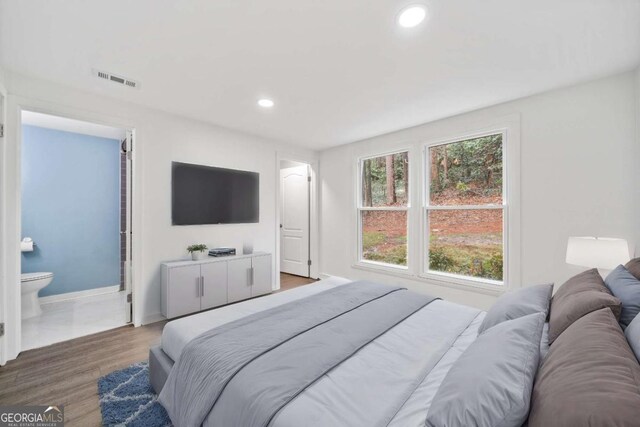 bedroom with visible vents, recessed lighting, baseboards, and wood finished floors
