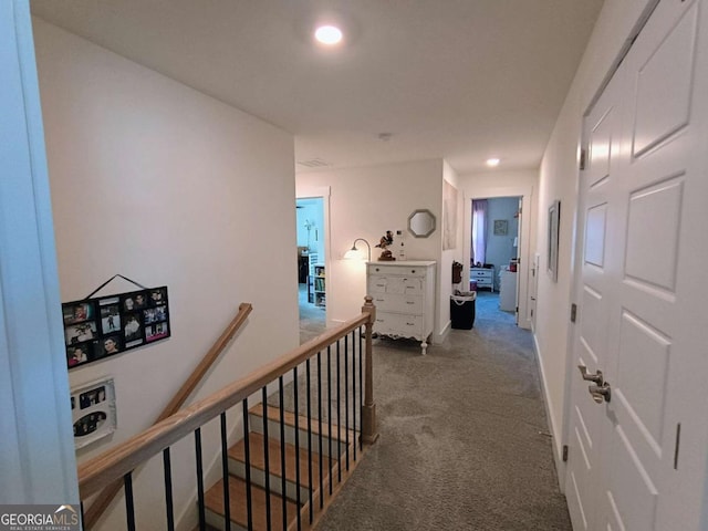 hallway with an upstairs landing, carpet flooring, and recessed lighting