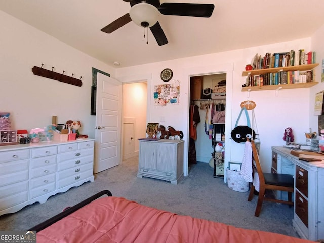 carpeted bedroom featuring a walk in closet, a ceiling fan, and a closet