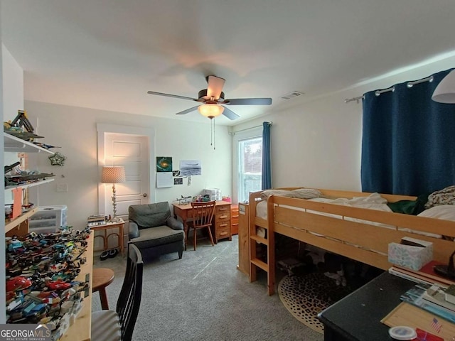 bedroom featuring visible vents, light colored carpet, and a ceiling fan