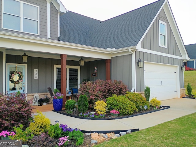 336 White Oak Way, Monroe, GA 30655 - view of front of house with board and batten siding, roof with shingles, a porch, an attached garage, and concrete driveway